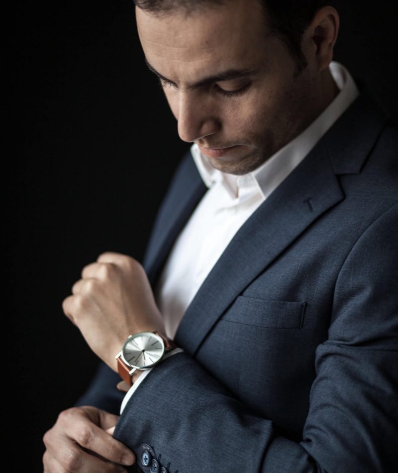 man-adjusting-his-sleeves-wearing-a-watch-1.jpg
